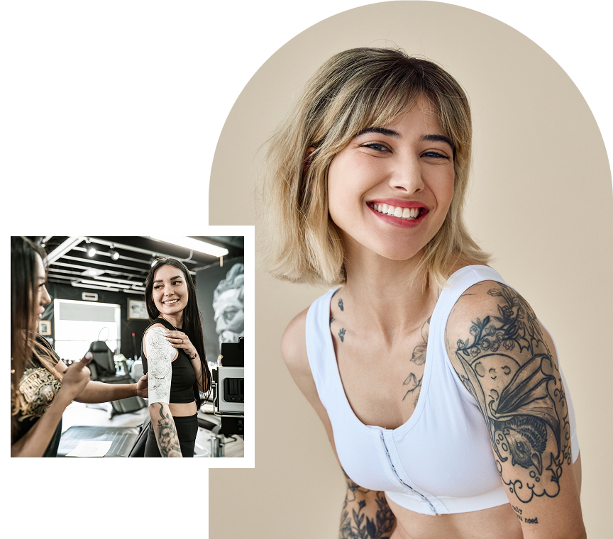 Happy woman with arm tattoos in white top
