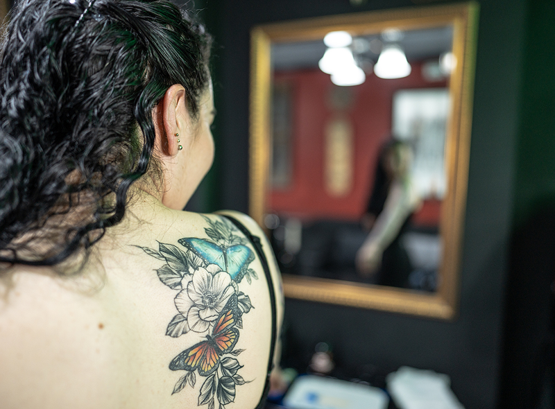 Colorful butterfly tattoo on woman's back